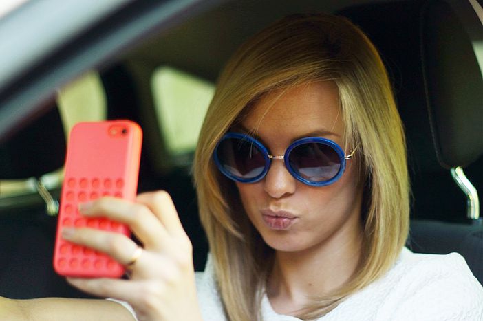 Molti giovani giocano con il telefono quando guidano l’auto