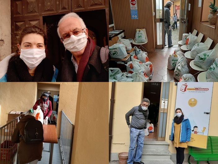 Il direttore Caritas Saluzzo don Beppe Dalmasso con i volontari dell'Emporio solidale di piazza Vineis