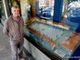 Mario Picco con il suo plastico di piazza del Popolo esposto nelle vetrine della Banca Cassa di Risparmio di Savigliano (foto di Doriano Mandrile)