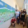 I ragazzi del &quot;Centro Riparo&quot; con i loro pannelli artistici nei corridoi del Municipio di Barge