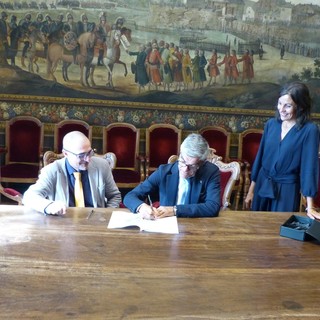 La firma del protocollo da parte Basilotta, Giraudo e Clerico